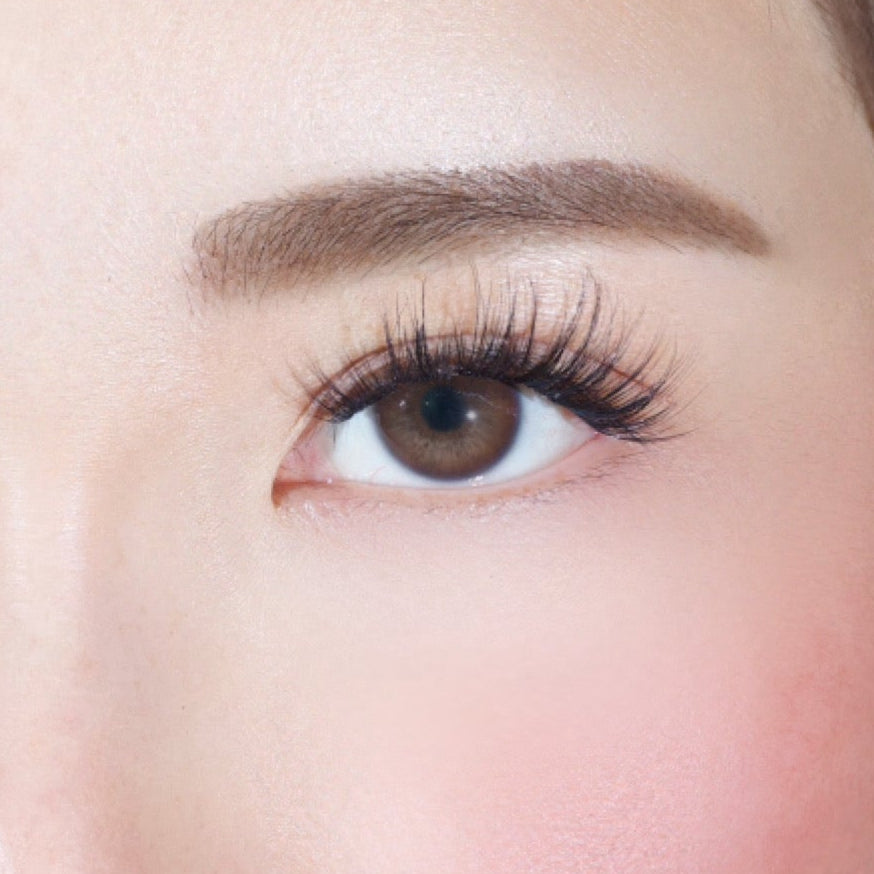 A close-up of a womans right eye with long lashes, well-groomed brow, and smooth skin—achieved effortlessly using Lashy Labs SASSY PRE-GLUED LASHES SET for a flawless look.