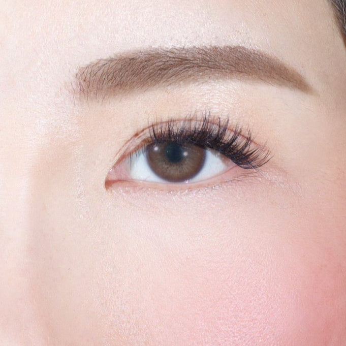 A close-up of a womans right eye with long lashes, well-groomed brow, and smooth skin—achieved effortlessly using Lashy Labs FLUTTER PRE-GLUED LASHES SET for a flawless look.