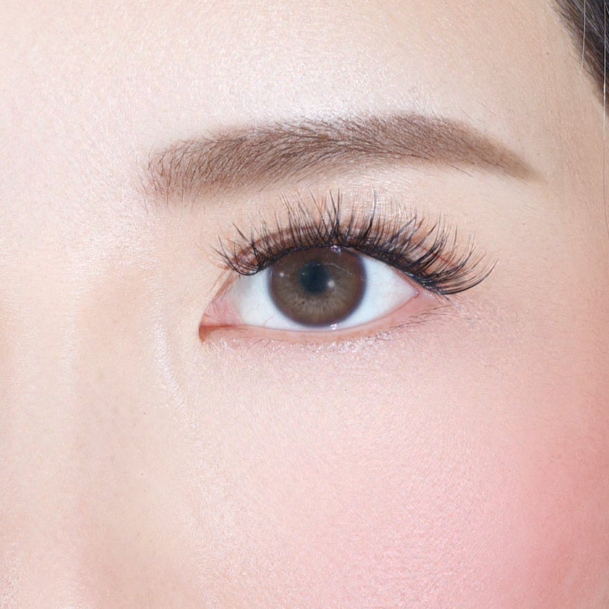 A close-up of a right eye with long lashes enhanced by Lashy Lab’s MOONLIGHT - Subtle, Light, Flare underlash extensions, paired with a well-groomed brow and smooth fair skin with a touch of pink blush.