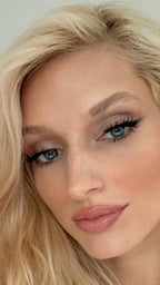 Woman with lashylab pro-cluster lashes nightout wearing a white top against a light background