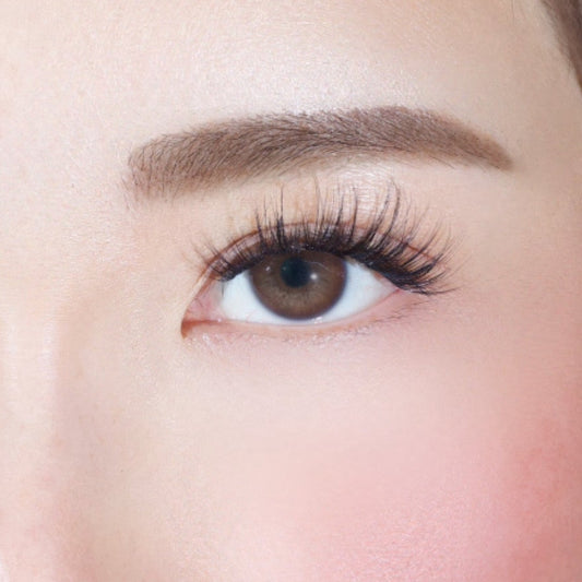 A close-up of a womans right eye with long lashes, well-groomed brow, and smooth skin—achieved effortlessly using Lashy Labs SASSY PRE-GLUED LASHES SET for a flawless look.