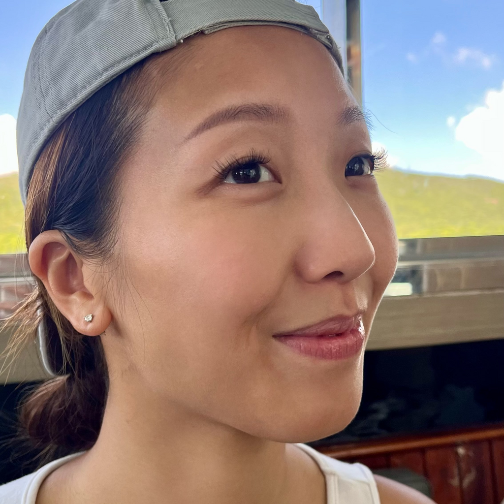 a lady wearing a pre-glued lashes. looking so happy and satisfied. 