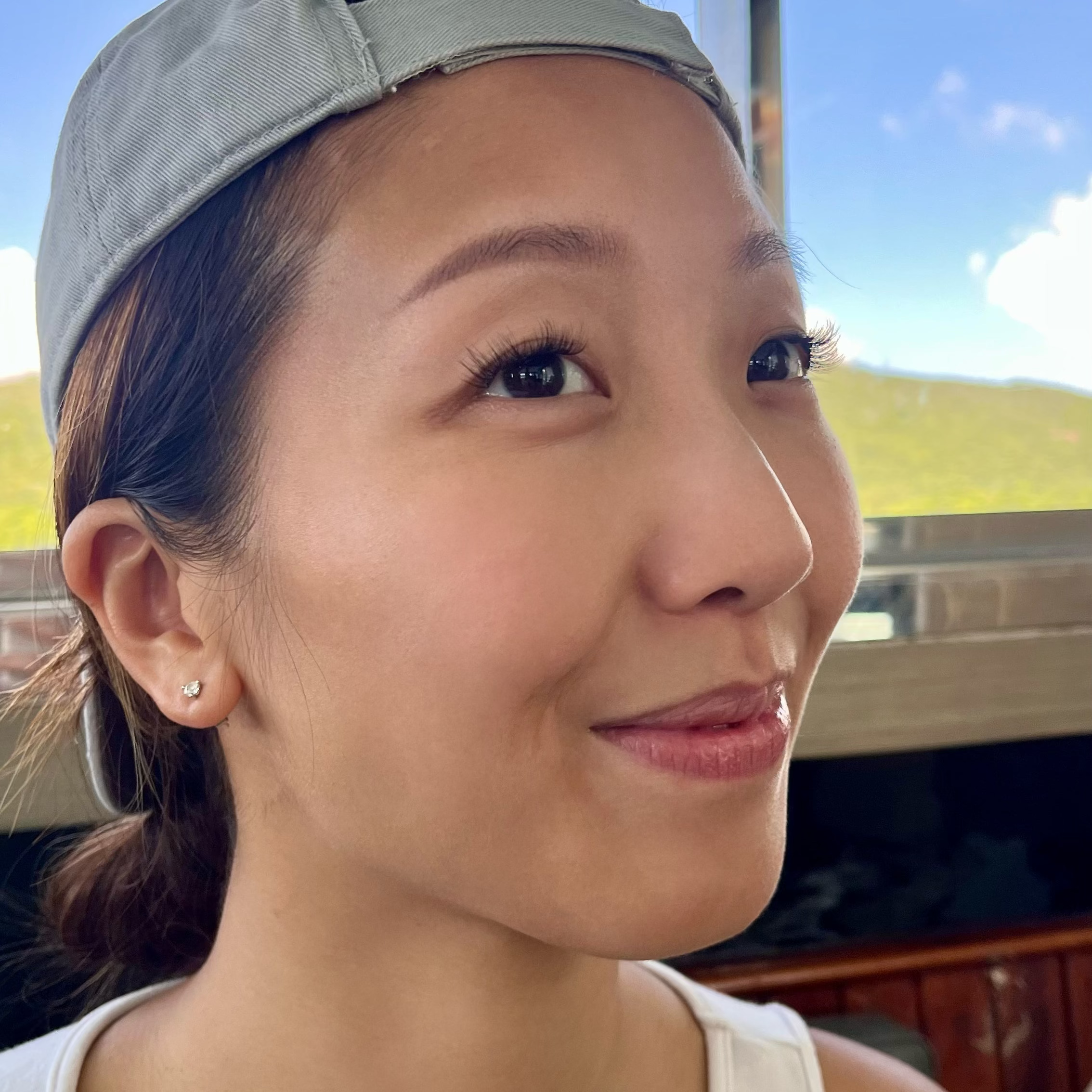 a lady wearing a pre-glued lashes. looking so happy and satisfied. 