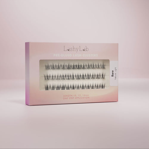 A box of pre-glued false eyelashes presented against a neutral background, with the brand name 'Lashy Lab' visible on the packaging.