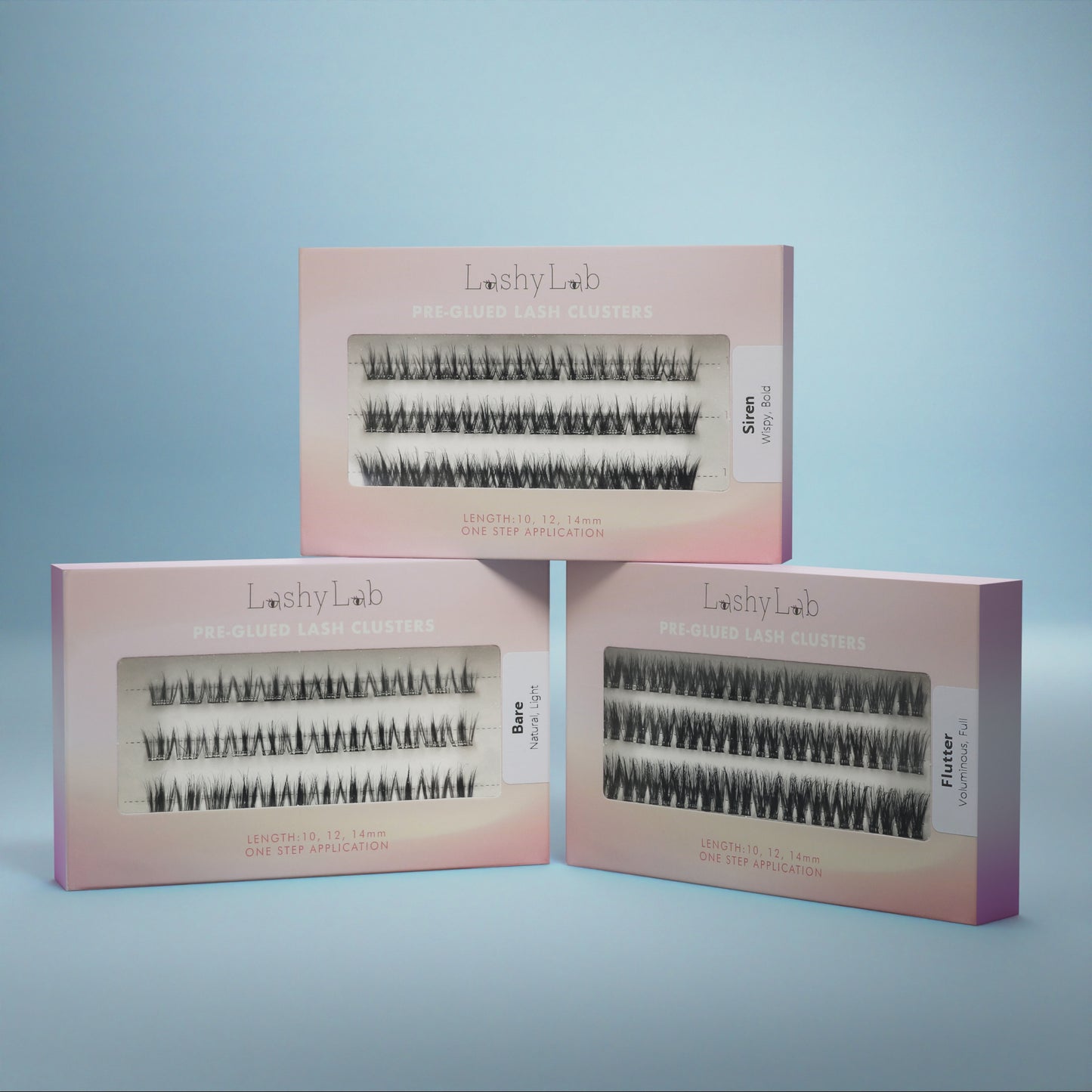 Three pink boxes of Lashy Lab’s PRE-GLUED LASHES MIX-MATCH BUNDLE in Wispy, Flare, and Flutter styles are shown against a blue background—ideal for easy DIY lash extensions that last for weeks.