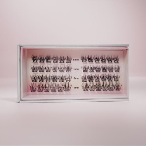 A box of CHIC GIRL Wispy, Trendy, Cat Eye pre-glued lashes by Lashy Lab, arranged in rows by length (8mm–14mm) on a pink background—ideal for those wanting long-lasting fake eyelashes.