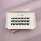 A white box labeled Lashy Lab SASSY PRE-GLUED LASHES SET holds three rows of pre-glued cluster lashes in assorted lengths, displayed on a pastel lilac and pink background for easy application.