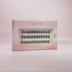 Lashy Lab’s SASSY set features pre-glued lashes in four lengths—8mm, 10mm and 12mm—for effortless, natural beauty. The lashes are arranged in rows and displayed against a pink background.