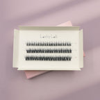 A white box labeled Lashy Lab SIREN PRE-GLUED LASHES SET holds three rows of pre-glued cluster lashes in assorted lengths, displayed on a pastel lilac and pink background for easy application.
